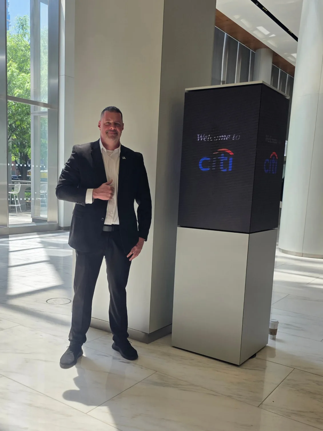 Shadow Securities executive protection agent standing inside the Citi corporate lobby in Manhattan