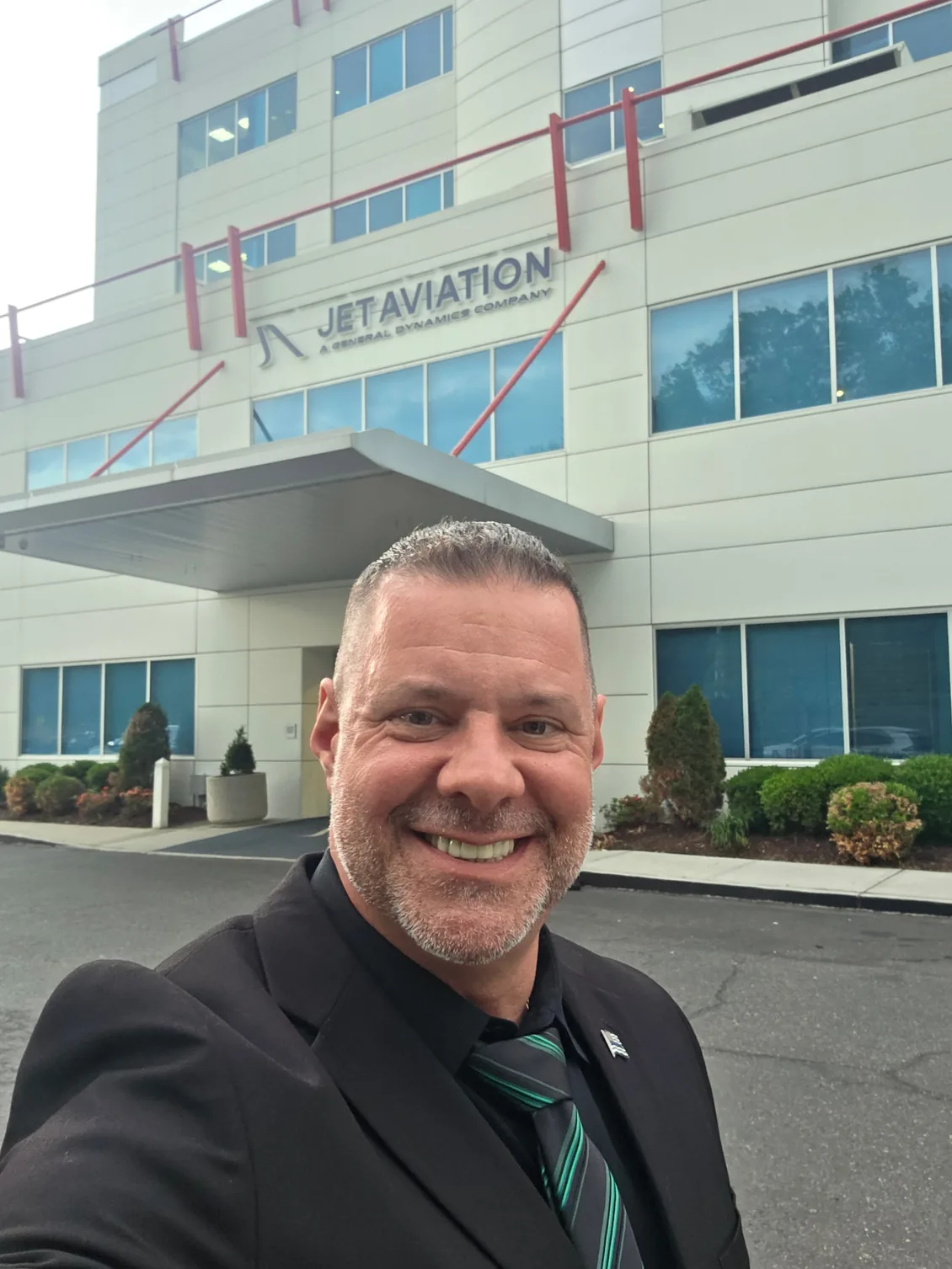 Shadow Securities armed security officer in a suit outside the Jet Aviation FBO terminal building in New Jersey