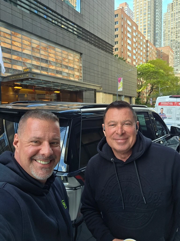 James Gonzales with a visiting protection agent beside an SUV in New York