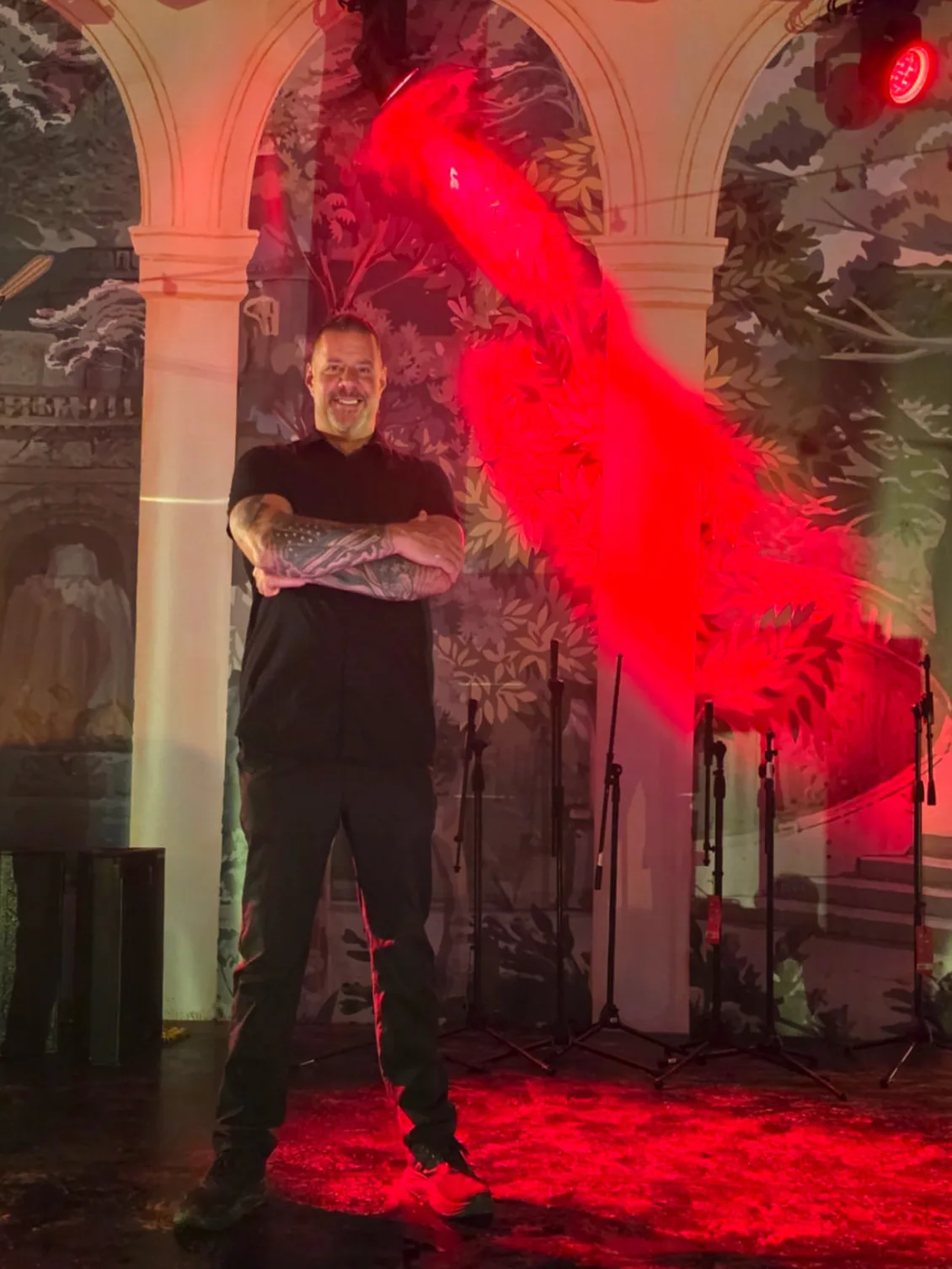 Protection agent standing post on a lit stage under a tented event ceiling