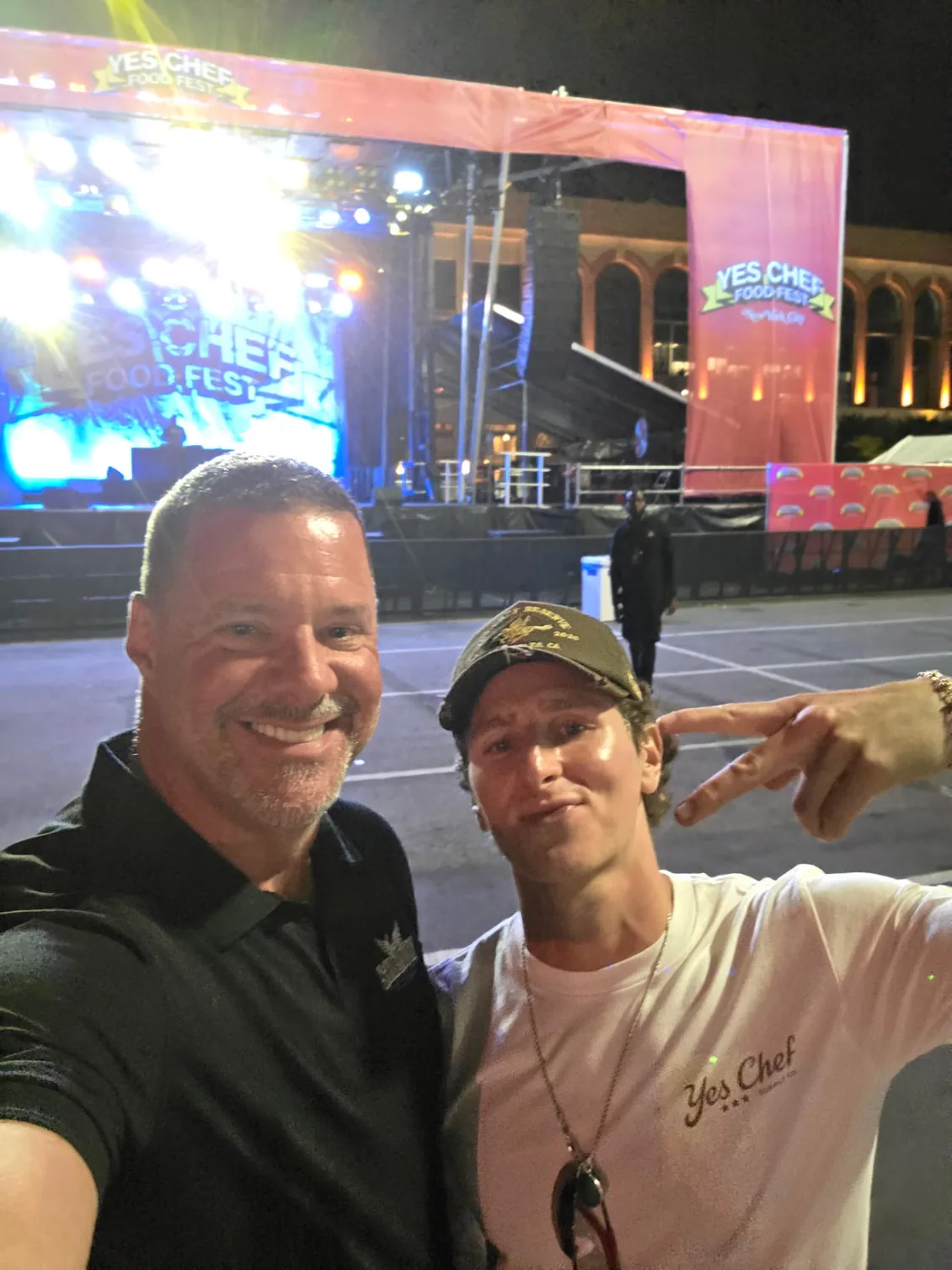 James Gonzales of Shadow Securities with Jack and the Yes Chef team near the main stage at night during Yes Chef Food Fest